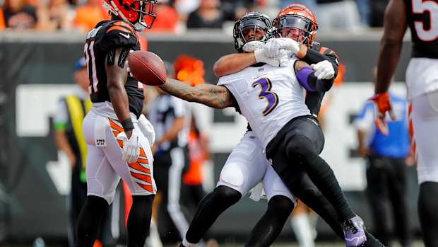 Cincinnati Bengals linebacker Logan Wilson tackles Baltimore Ravens wide receiver Odell Beckham Jr.