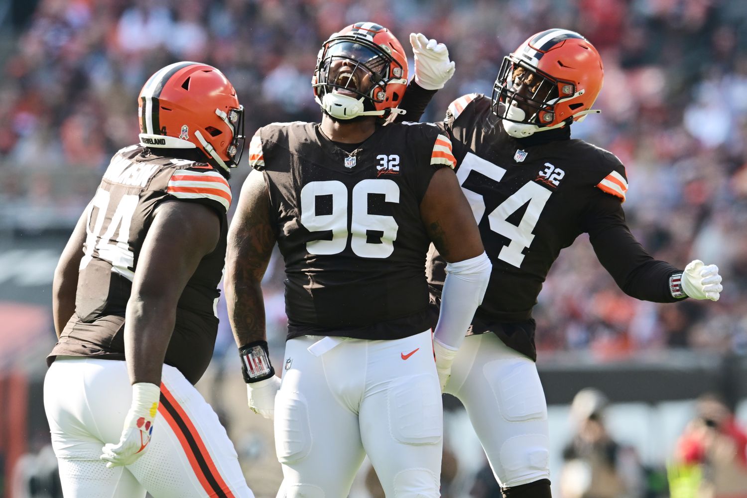 Nov 5, 2023; Cleveland, Ohio, USA; Cleveland Browns defensive tackle Jordan Elliott (96) celebrates a sack with defensive tackle Dalvin Tomlinson (94) and defensive end Ogbo Okoronkwo (54) during the first quarter against the Arizona Cardinals at Cleveland Browns Stadium. Mandatory Credit: Ken Blaze-USA TODAY Sports