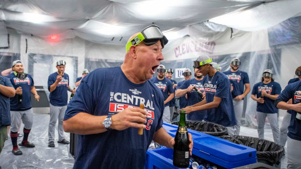 Sep 25, 2022; Arlington, Texas, USA; Cleveland Guardians manager Terry Francona (77) celebrates with his team in the locker room after the Guardians clinch their first AL Central title since 2018 after the victory over the Texas Rangers at Globe Life Field. Mandatory Credit: Jerome Miron-USA TODAY Sports