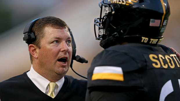 Gerquan Scott (right) with Southern Miss head coach Will Hall.
