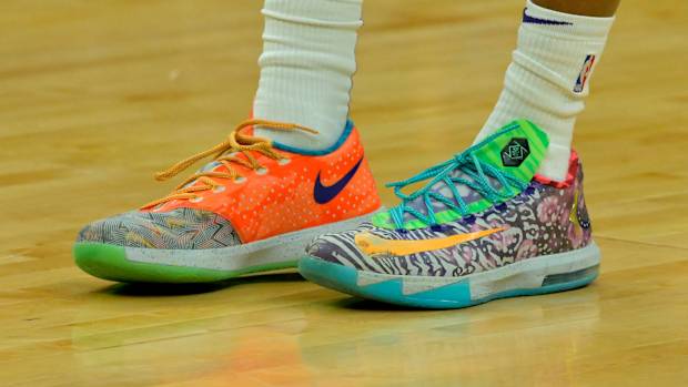 View of orange and green Nike KD shoes.