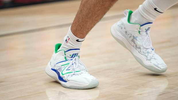 View of Jamal Murray's white, green, and blue New Balance shoes.
