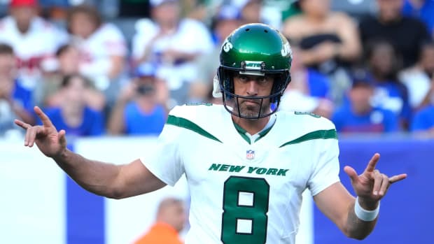 New York Jets quarterback Aaron Rodgers (8) greets the cheers of fans on his first appearance as a Jet against the Giants at MetLife Stadium.