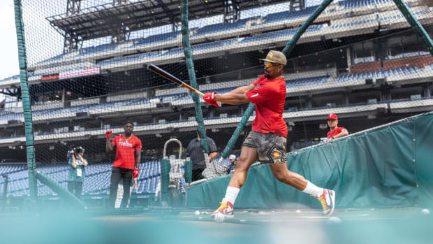 Jalen Hurts takes batting practice before a Philadelphia Phillies game.
