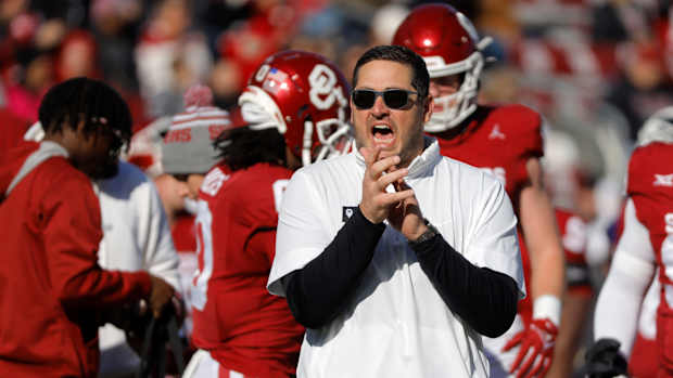 Oklahoma offensive coordinator Jeff Lebby claps and shouts as the Oklahoma Sooners warm up before a college football game between the University of Oklahoma Sooners (OU) and the TCU Horned Frogs at Gaylord Family-Oklahoma Memorial Stadium in Norman, Okla., Friday, Nov. 24, 2023. Oklahoma won 69-45.  