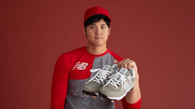 Shohei Ohtani holding cleats.