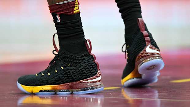 View of black and gold Nike LeBron shoes.