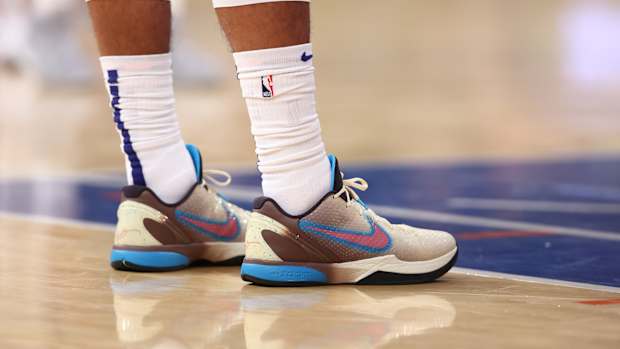 View of pink and blue Nike Kobe shoes.