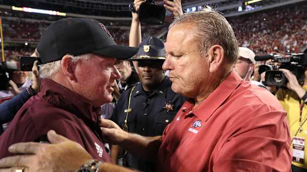 Texas A&M offensive coordinator Bobby Petrino embraces Arkansas head coach Sam Pittman while serving as head coach at Missouri State 