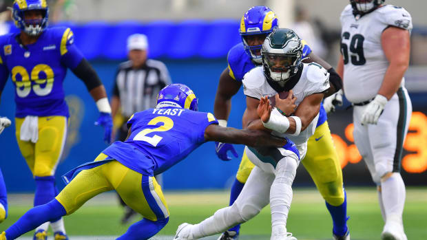 Philadelphia Eagles quarterback Jalen Hurts (1) runs the ball against Los Angeles Rams safety Russ Yeast (2) during the first half at SoFi Stadium.