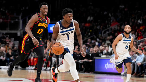 Timberwolves guard Anthony Edwards dribbles past Hawks forward Onyeka Okongwu.
