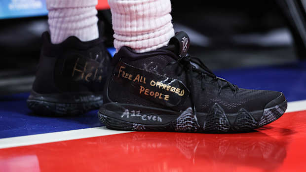 View of Kyrie Irving's black Nike shoes.