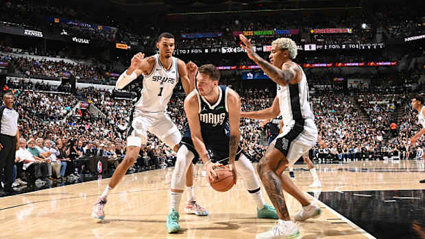 Dallas Mavericks superstar Luka Doncic gets trapped by San Antonio Spurs' Victor Wembanyama and Jeremy Sochan. 