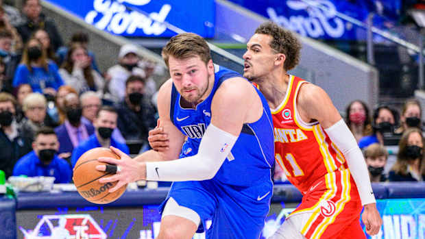 Hawks guard Trae Young defends Mavericks guard Luka Doncic.