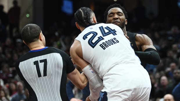 Feb 2, 2023; Cleveland, Ohio, USA; Cleveland Cavaliers guard Donovan Mitchell (45) fights with Memphis Grizzlies forward Dillon Brooks (24) as referee Jonathan Sterling (17) tries to break them apart during the second half at Rocket Mortgage FieldHouse.
