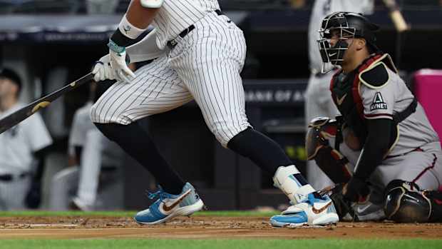 Detailed view of Aaron Judge's blue, white, and red Air Jordan cleats.