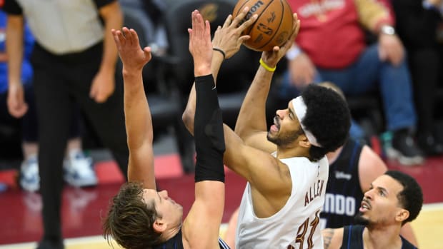 Feb 22, 2024; Cleveland, Ohio, USA; Cleveland Cavaliers center Jarrett Allen (31) shoots beside Orlando Magic center Moritz Wagner (21) in the fourth quarter at Rocket Mortgage FieldHouse. Mandatory Credit: David Richard-USA TODAY Sports