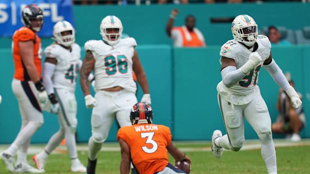 Miami Dolphins defensive end Emmanuel Ogbah (91) celebrates a sack Denver Broncos quarterback Russell Wilson (3) during the fourth quarter of an NFL game at Hard Rock Stadium in Miami Gardens, Sept. 24, 2023.