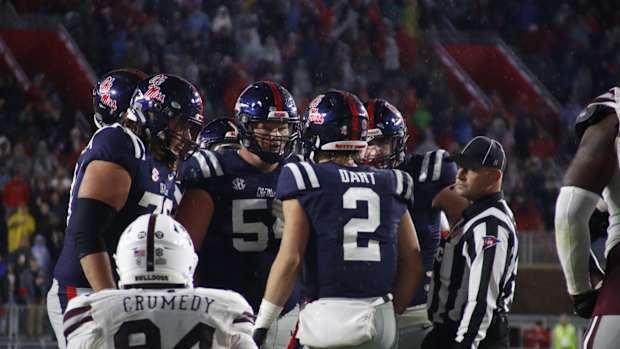 Jaxson Dart Ole Miss huddle navy