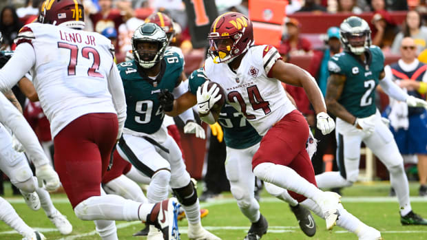 Former Washington Commanders running back Antonio Gibson (24) runs the ball against the Philadelphia Eagles.