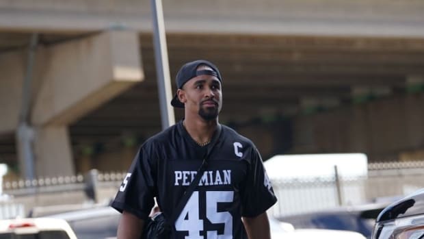Philadelphia Eagles quarterback Jalen Hurts wore a throwback jersey and Nike Dunk Low sneakers before a preseason NFL game.