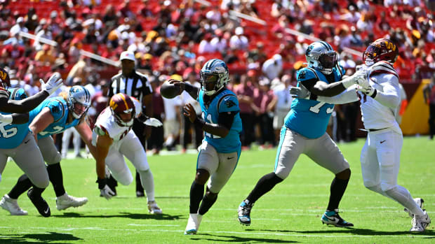 Aug 13, 2022; Landover, Maryland, USA; Carolina Panthers quarterback PJ Walker (11) scrambles against the Washington Commanders during the second half at FedExField. Mandatory Credit: Brad Mills-USA TODAY Sports
