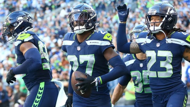 Tariq Woolen #27 of the Seattle Seahawks celebrates an interception against the Arizona Cardinals during the fourth quarter at Lumen Field on October 16, 2022 in Seattle, Washington.
