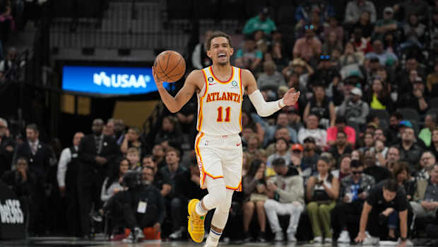 Atlanta Hawks guard Trae Young dribbles the ball.