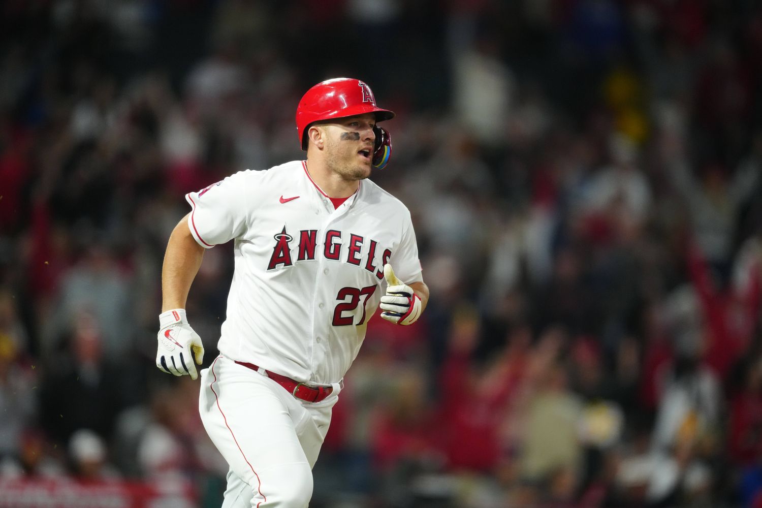 Los Angeles Angels center fielder Mike Trout hits a home run against the Boston Red Sox.