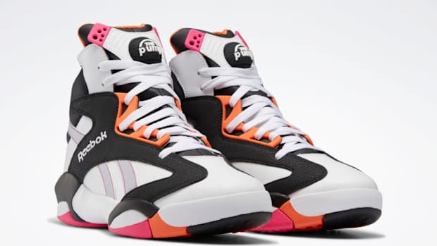 View of white, black, and orange Reebok sneakers.