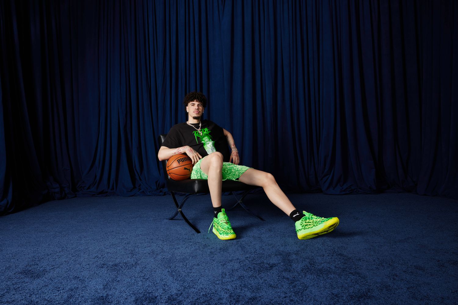 LaMelo Ball models green and black PUMA apparel.