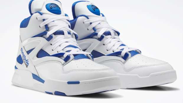 View of white and blue Reebok shoes.