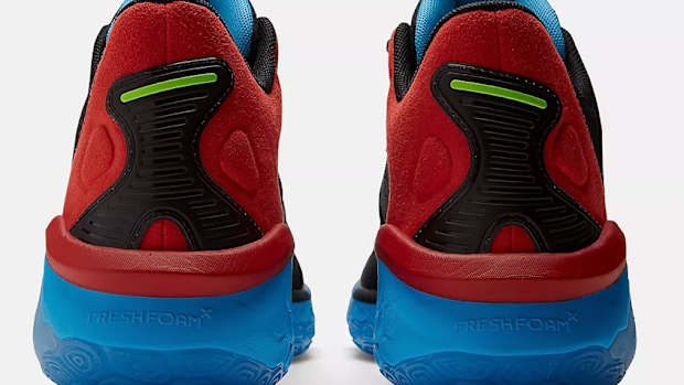 Rear view of red and blue New Balance shoes.