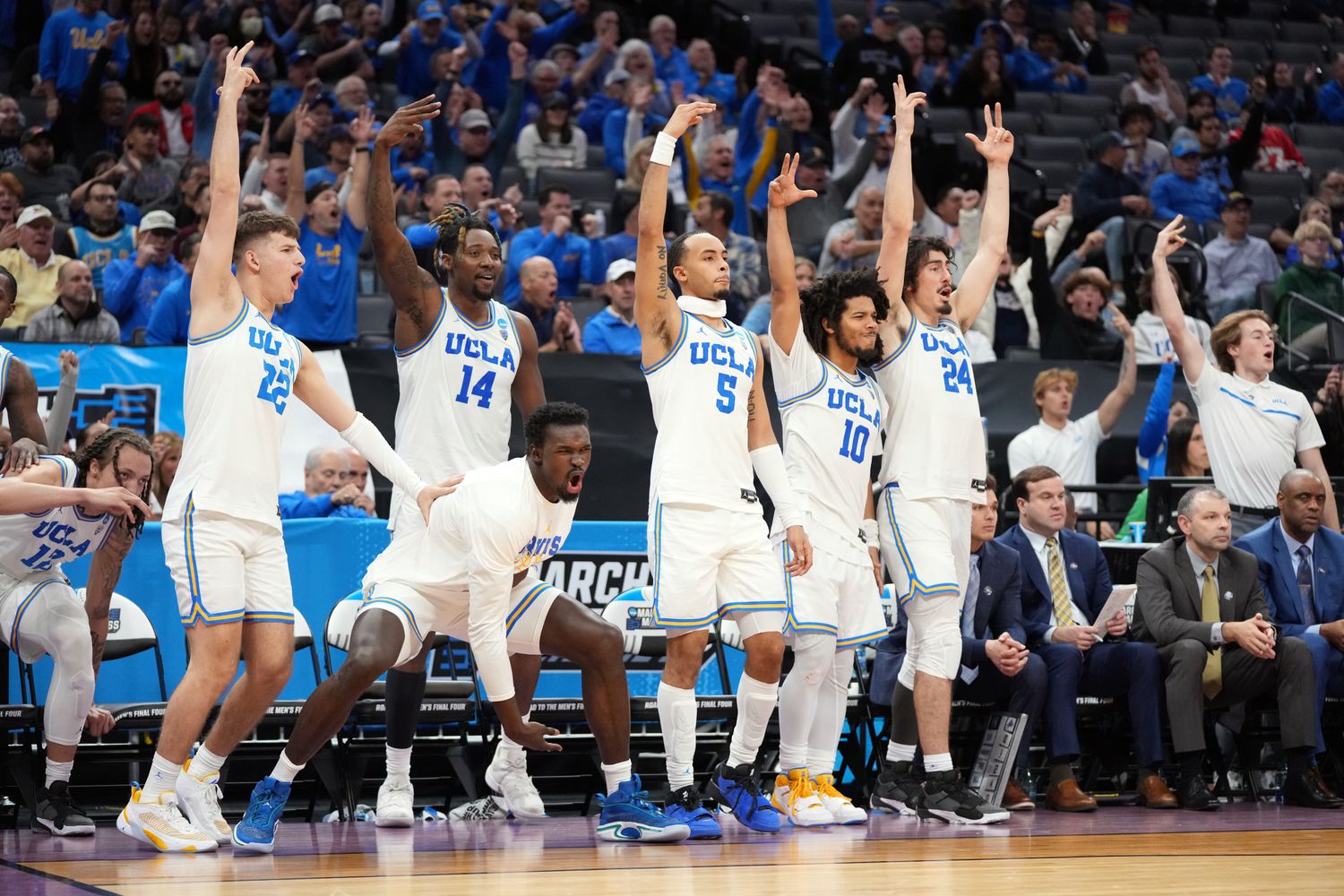 The UCLA Bruins bench celebrates during a game.