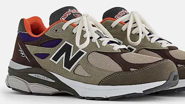 View of brown and orange New Balance shoes.