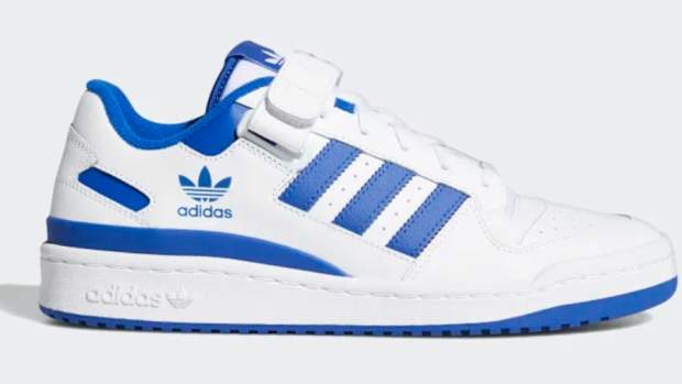 Side view of white and blue adidas shoes.