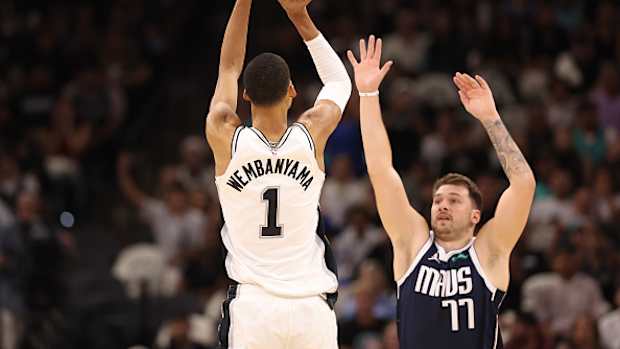 Luka Doncic does his best to contest Victor Wembanyama’s shot.