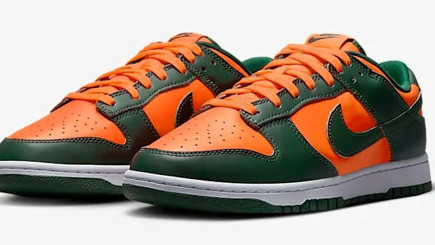 Side view of green and orange Nike Dunk shoes.