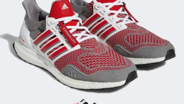 View of grey and red adidas shoes.