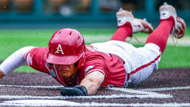 Arkansas first baseman Brady Slavens slides into home head first against Vanderbilt.