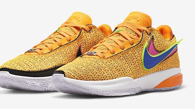 Side view of LeBron James' orange and blue Nike shoes.