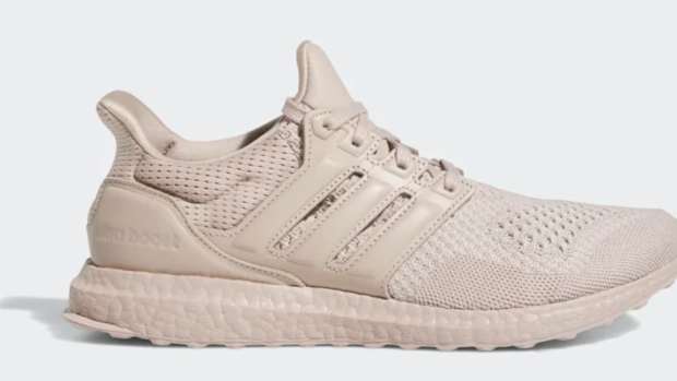 Side view of a tan adidas shoe.