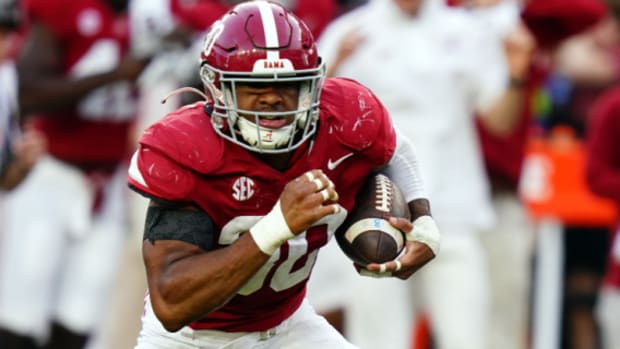 Alabama Crimson Tide linebacker Jihaad Campbell returns a fumble during a college football game in the SEC.