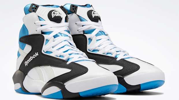 White, black, and blue Reebok Shaq shoes.