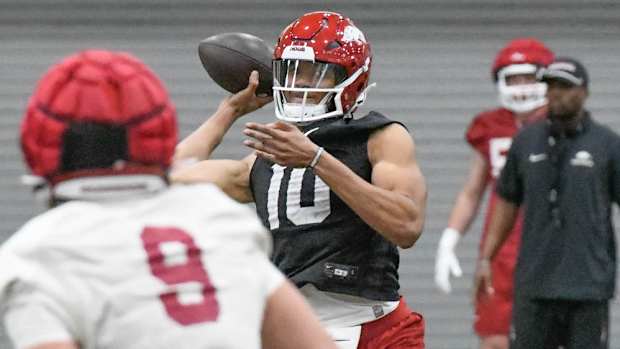 Razorbacks' quarterback Taylen Green throwing a pass in Friday practice