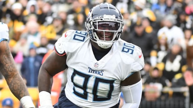 Tennessee Titans defensive tackle Naquan Jones (90) celebrates a sack of Pittsburgh Steelers quarterback Ben Roethlisberger (7) during the first quarter against the Pittsburgh Steelers at Heinz Field.
