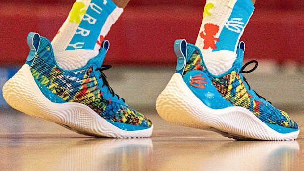 View of blue, yellow, and Curry 10 shoes.