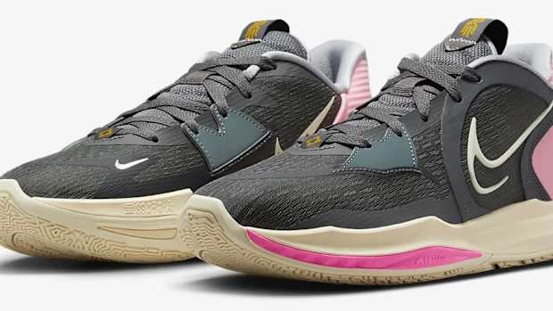 View of black and pink Nike shoes.