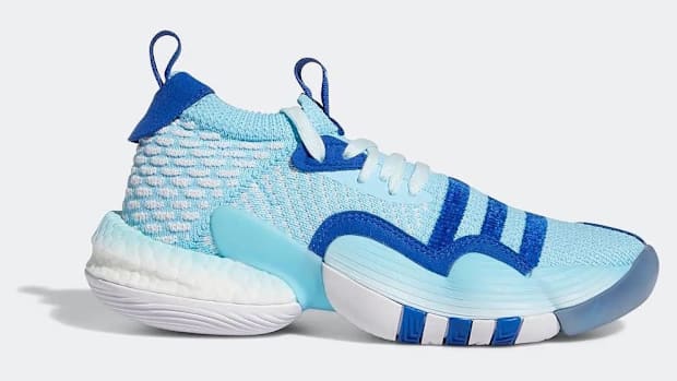 Side view of Trae Young's blue and white adidas shoe.