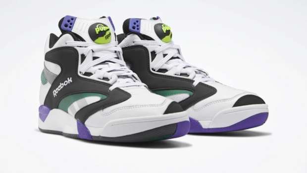 View of white, black, and purple Reebok shoes.